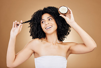 Image showing Hair, growth and coconut with woman and beauty, natural cosmetics and skin isolated on studio background. Health, oil or cream product with fruit, eco friendly for texture and shine with haircare