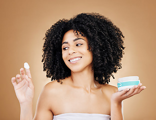 Image showing Studio beauty, face and happy woman with cream treatment, sunscreen container and facial glow, shine or cosmetology. Cosmetics girl, self care creme and collagen hydration product on brown background
