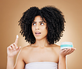 Image showing Skincare problem, thinking and woman with cream container, beauty product or shocked over facial treatment. Skin hydration, studio dermatology or self care model with cosmetic on brown background