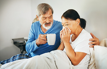 Image showing Sick senior woman in bed with husband blowing her nose with tissue for flu, allergies or cold. Love, comfort and elderly man in retirement hugging his ill wife in bedroom of modern home on a weekend.