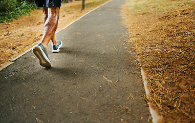 Image showing Man, fitness and legs on road for running or workout in outdoor exercise or training in nature. Closeup of male person, athlete or runner on path, sidewalk or asphalt for cardio, walking or wellness