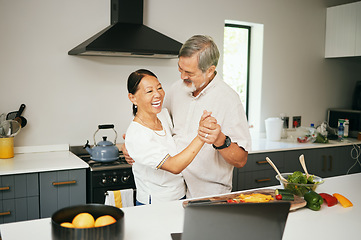 Image showing Senior couple, dancing and kitchen while cooking, happiness and love at home, fun and romantic. Retirement, bonding together and smile for food, elderly and quality time with joke, retired or elderly