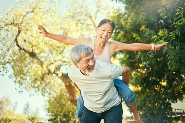 Image showing Couple, smile and piggyback in nature for fun, excited and playful in freedom, energy and joy. Happy elderly asian people, airplane and flying in summer, laugh and support for crazy in retirement