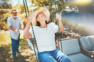 Image showing Woman, smile and fun on swing in retirement, playful and joy in summer vacation for quality time. Happy elderly people, support and love in relationship, funny and laugh for silly, goofy and holiday