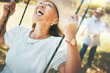 Image showing Woman, laugh and fun on swing in retirement, playful and energy in summer vacation for quality time. Happy old people, support and love in relationship, funny and excited for silly, goofy and holiday