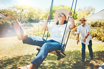 Image showing Woman, happy and fun on swing in retirement, playful and joy in summer vacation for quality time. Elderly people, support and love in relationship, funny and laugh for silly, goofy and holiday