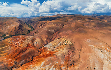 Image showing Aerial shot of the textured yellow nad red mountains resembling the surface of Mars