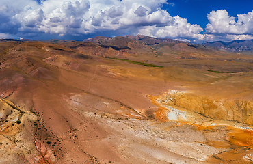 Image showing Aerial shot of the textured yellow nad red mountains resembling the surface of Mars