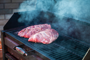 Image showing Pork meat steaks on the grill