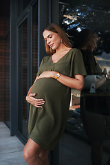 Image showing Future, smile and a pregnant woman on an office balcony for business waiting to be a mother. Stomach, pregnancy and happy young employee at the workplace as an employee thinking about maternity leave