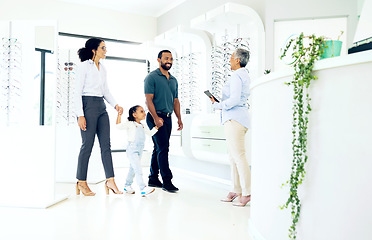 Image showing Optometrist, parents and girl child with optician for eye care, eyes assessment or prescription glasses. Family, man or women in store with happiness for visit, appointment or vision test for eyewear