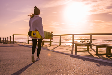 Image showing Girl holding a skateboard 