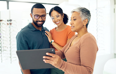 Image showing Tablet, optometry and woman with patients in a store for spectacle frame browsing on the internet. Consultation, digital technology and optometrist with people for choosing glasses in optical clinic.