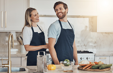 Image showing Kitchen, apron and couple with cooking, smile and healthy food with ingredients, bonding and anniversary. Happy people, home and man with woman, recipe and bonding with activity, lunch and vegetables