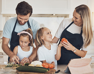 Image showing Vegetables, cooking and family in kitchen together for bonding and preparing dinner, lunch or supper. Happy, smile and girl children cutting ingredients with parents for a healthy diet meal at home.