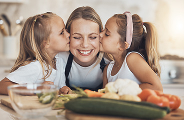Image showing Kitchen, cooking and mother with girls, kissing and love with bonding, happiness and weekend break. Family, mama or children with mom, kids or ingredients with a smile, home or care with healthy food