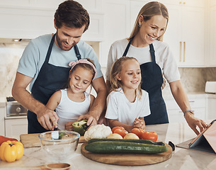 Image showing Happy, cooking and family in the kitchen together for bonding and preparing dinner, lunch or supper. Love, smile and girl children cutting vegetables or ingredients with parents for a meal at home.