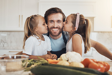 Image showing Portrait, family and kiss on the cheek from girl kids with their father in the kitchen of a home for cooking together. Face, smile and sisters with their happy parent in the house to make a meal