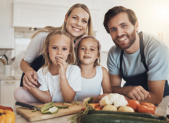 Image showing Portrait, cooking and happy family in kitchen together for bonding and preparing dinner, lunch or supper. Love, smile and girl children cutting vegetables or ingredients with parents for meal at home