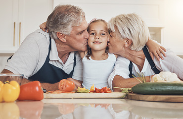Image showing Family, cooking and grandparents kiss girl child in kitchen with love, care and support at home. Food, learning and face of kid with elderly people together with vegetables, nutrition or prepare meal