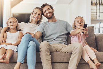 Image showing Home, watching tv and family with girls on a sofa, relax and happiness with fun, movies and support on a weekend break. Children, mother and father with kids, films and series with care and cheerful
