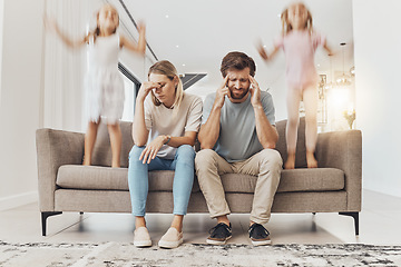 Image showing Frustrated parents, sofa and headache with children jumping in living room chaos, ADHD or crazy home. Mother and father in stress, burnout or fatigue with busy or hyper active kids in lounge at house