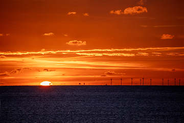 Image showing Sun setting over English Channel with Rampion Wind Turbines