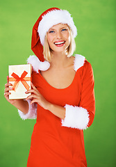 Image showing Woman, Christmas and outfit holiday gift in studio for festive, season or smile. Female person, costume and portrait on green background or present box, excited celebration, winter break or vacation