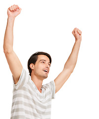 Image showing Happy man, winner and hand up for success in competition, celebration and white background in studio. Positive person, cheer and smile with casual aesthetic for victory, good news or goal achievement