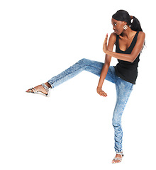 Image showing Woman, kick and studio for fashion beauty luxury designer wear, trendy style or unique funny. African female, martial arts hands or mockup fun pose for cool clothes or jeans outfit good mood or youth
