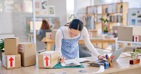 Image showing Ecommerce, Asian woman with checklist and boxes at laptop, reading sales or inventory at fashion startup. Online shopping, delivery and small business owner, stock list for web shop package checking.