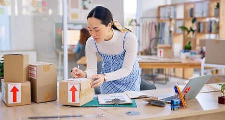 Image showing Ecommerce, Asian woman with checklist and boxes at laptop, reading sales or inventory at fashion startup. Online shopping, delivery and small business owner, stock list for web shop package checking.