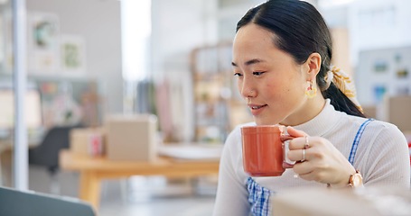 Image showing Ecommerce, Asian woman at laptop with coffee and boxes, checking sales email or work at fashion startup. Online shopping, distribution and small business owner with drink, computer and review at desk