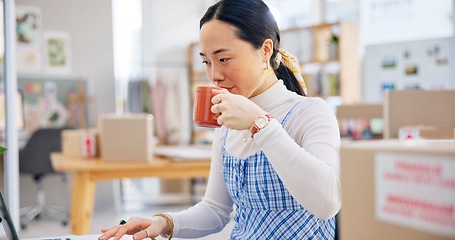 Image showing Ecommerce, Asian woman at laptop drinking coffee and typing email, checking sales and work at fashion startup. Online shopping, boxes and small business owner with drink, computer and website at desk