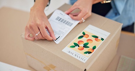 Image showing Online order, delivery label and woman hand with small business sticker for cardboard box. Stock, startup process and sales of ecommerce and boutique at home of a entrepreneur with courier package