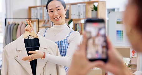 Image showing Fashion influencer, phone and Asian woman live streaming clothes, leather jacket design or shooting vlog commercial. Cellphone recording, social media app and Japanese person explain retail product