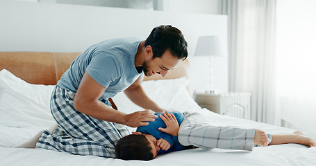 Image showing Play, father and son with love, bed and fun with happiness, quality time and energy on a weekend break. Male parent, boy and dad with kid, bedroom and relax with humor, home and carefree on vacation