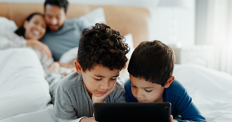 Image showing Brothers, children and tablet with parents on bed for game, movies or relax together with mom, dad and laugh. Happy family, boy kids and digital touchscreen for app, learning or development in home