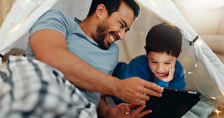 Image showing Bonding, tablet and father in a tent with kid watching a movie, video or show online. Happy, smile and young dad networking on social media with boy kid on digital technology in blanket fort at home.