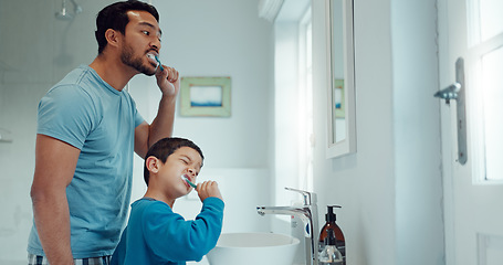 Image showing Father, child and brushing teeth in family home bathroom while learning or teaching dental hygiene. A man and kid with toothbrush and toothpaste for health, cleaning mouth and wellness at mirror