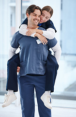 Image showing Couple, hospital and doctors piggy back for love, happy relationship and work romance in clinic. Healthcare team, dating and playful man and woman for medical service, support and medicare career