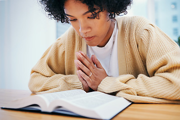 Image showing Woman, bible and prayer at desk, religion and Christian worship in home at table. Person, holy book and meditation for God, Jesus Christ and studying for faith in spiritual gospel, praise or reading