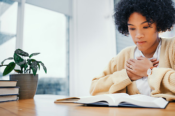 Image showing Bible, prayer and woman studying religion at desk in home, Christian faith and knowledge of God for hope. Reading, praise and girl at table with holy book, learning gospel for inspiration or theology