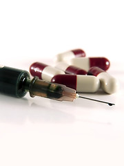 Image showing Pills and medical syringe