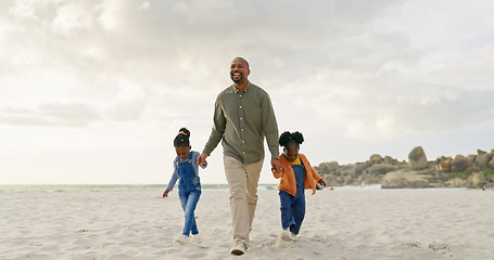 Image showing Walking, father and children holding hands at the beach for bonding, summer freedom and care. Happy, family and an African dad with affection for kids on a walk in the sand at the ocean on holiday