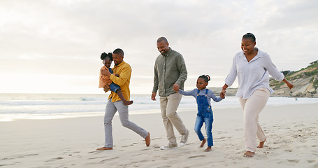 Image showing Happy, walking and a black family at the beach, holding hands and talking on a holiday. Sunset, conversation and grandparents, father and children on a walk by the sea during a vacation for travel