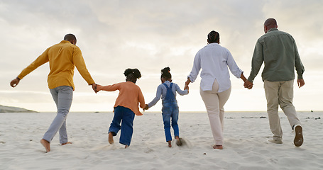 Image showing Happy, love and holding hands with black family at beach for summer, vacation and relax. Holiday, support and travel with parents and children walking on coastline for care, trust and freedom