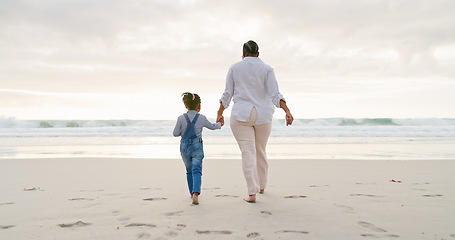 Image showing Black family, mother and daughter holding hands, beach and bonding with love and care, back view and walk outdoor. Sea, freedom and travel, woman and girl on holiday with trust and support in nature