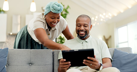 Image showing Black couple, laughing and tablet on a home sofa for streaming, meme and internet in a living room. African woman and man together to talk about tech, funny post or video on social media or network