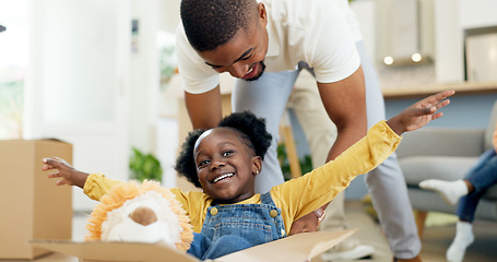 Image showing Father, playing and child in a box while moving house with a black family together in a living room. Man and a girl kid excited about fun game in their new home with a smile, happiness and energy